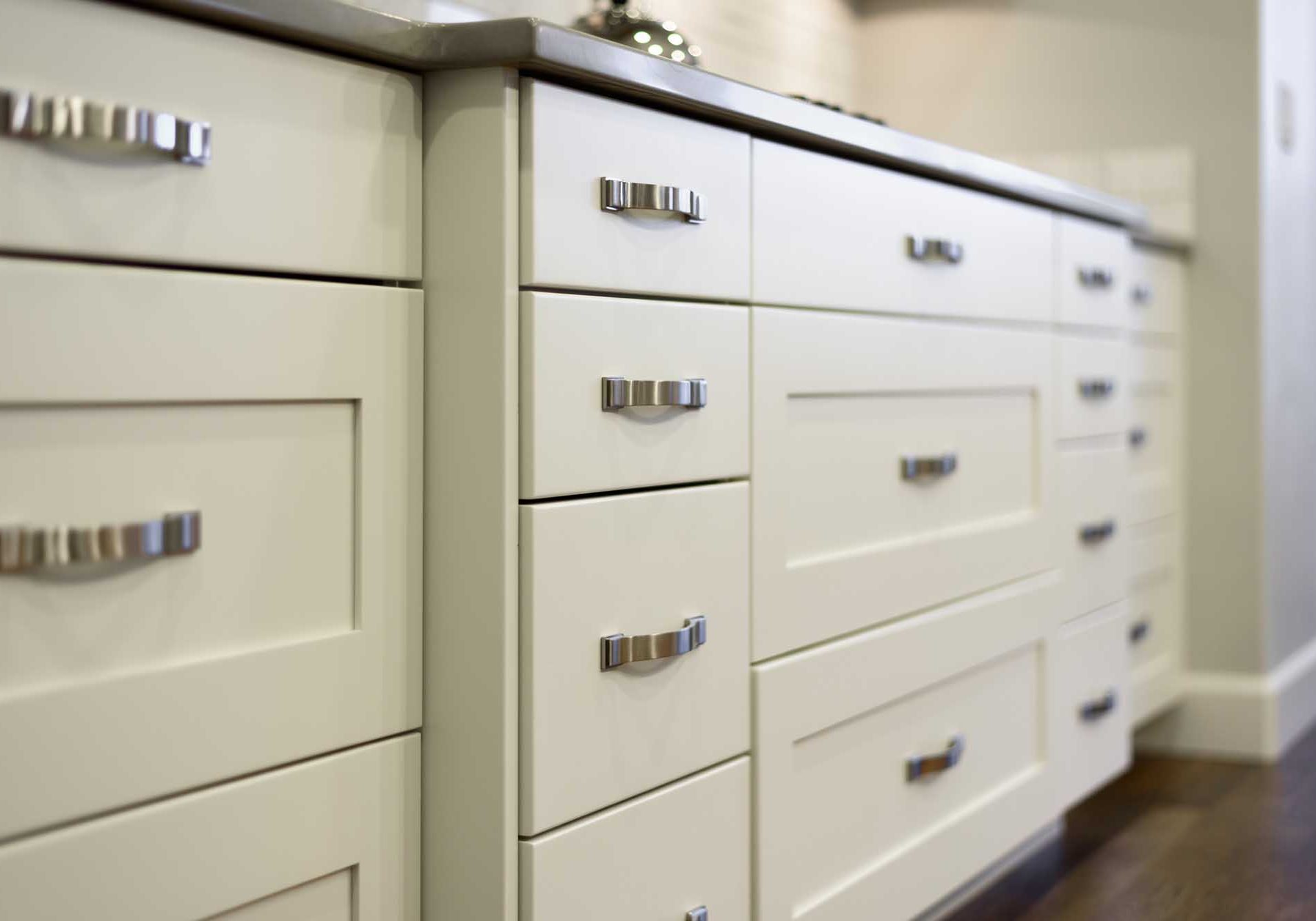 white kitchen cupboards with silver handles