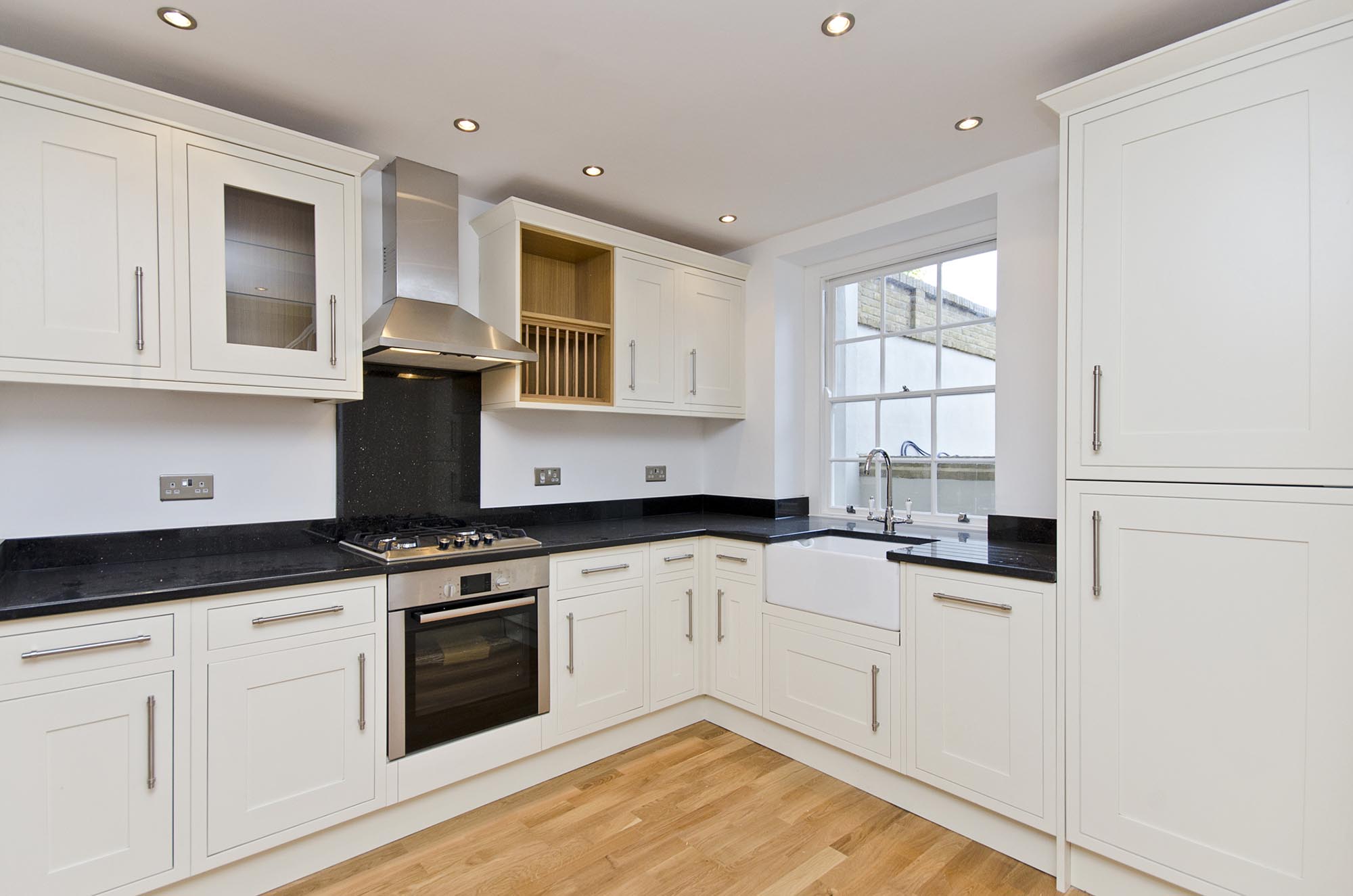 white kitchen with black countertops